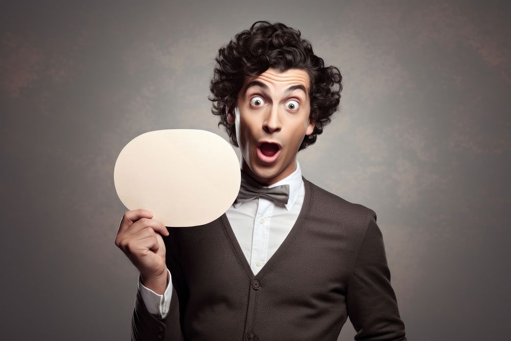 Young man holding empty speech bubble paper surprised portrait adult. AI generated Image by rawpixel.