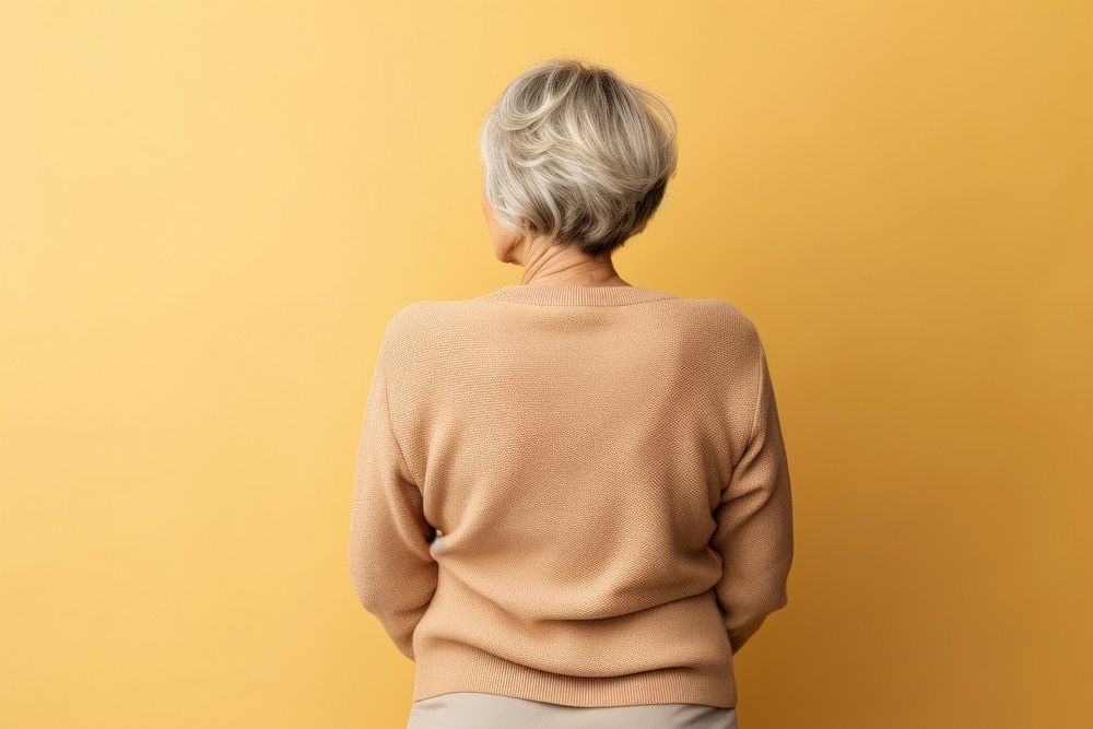 Older woman hug herself back sweater adult. AI generated Image by rawpixel.