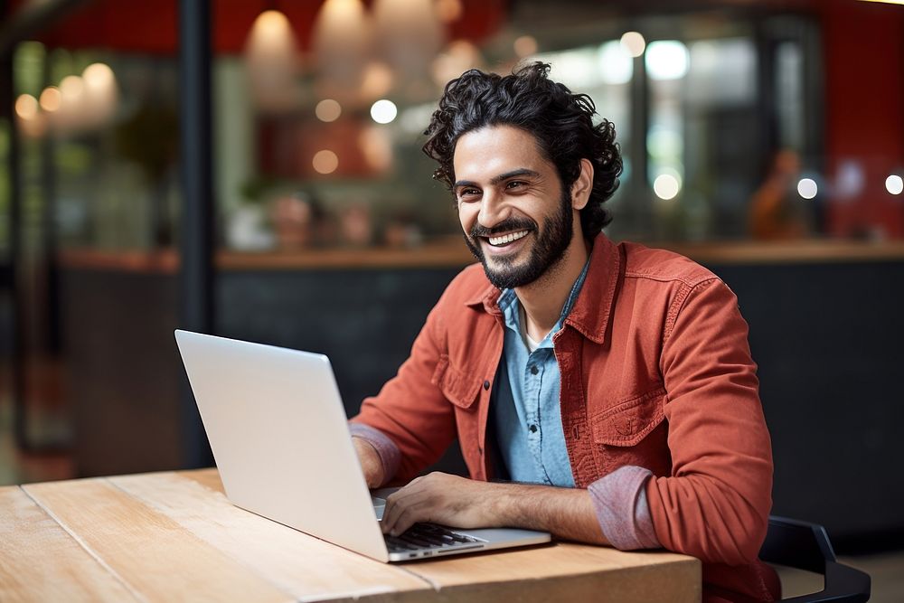 Mexican man working on laptop computer smiling smile. AI generated Image by rawpixel.