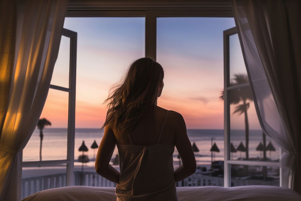 Woman wakes up window beach hotel. AI generated Image by rawpixel.