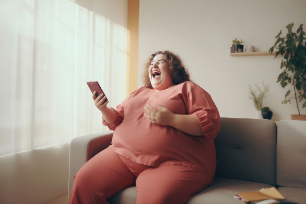 Happy relaxed chubby woman using cell phone laughing sitting smiling. AI generated Image by rawpixel.