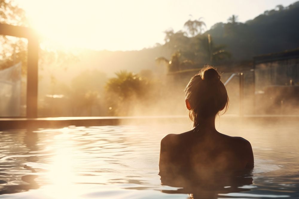 Young woman relaxing doing spa outdoors swimming adult. AI generated Image by rawpixel.