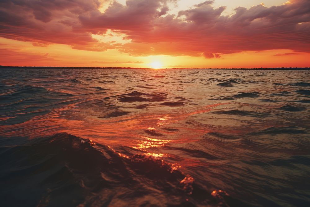 Sunset over water landscape outdoors horizon. AI generated Image by rawpixel.