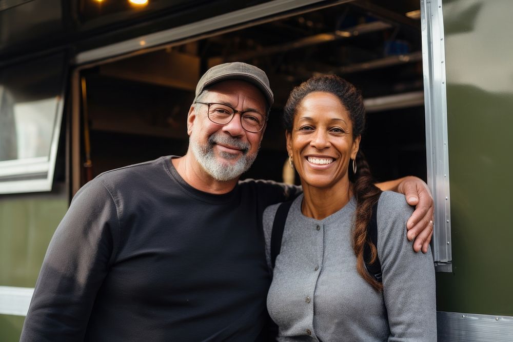 A multiracial middle age couple in front of food truck portrait smiling glasses. AI generated Image by rawpixel.
