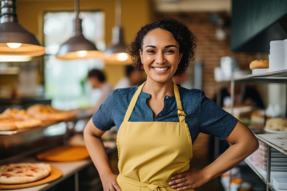 A middle age multiracial woman in apron at pizza shop adult bread food. AI generated Image by rawpixel.