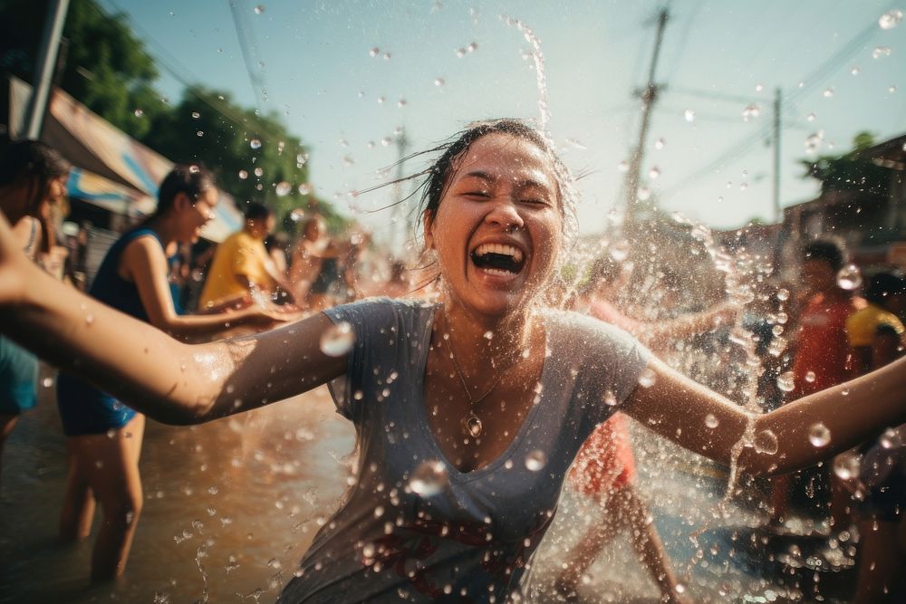People playing water at songkran festival in thailand laughing adult togetherness. AI generated Image by rawpixel.
