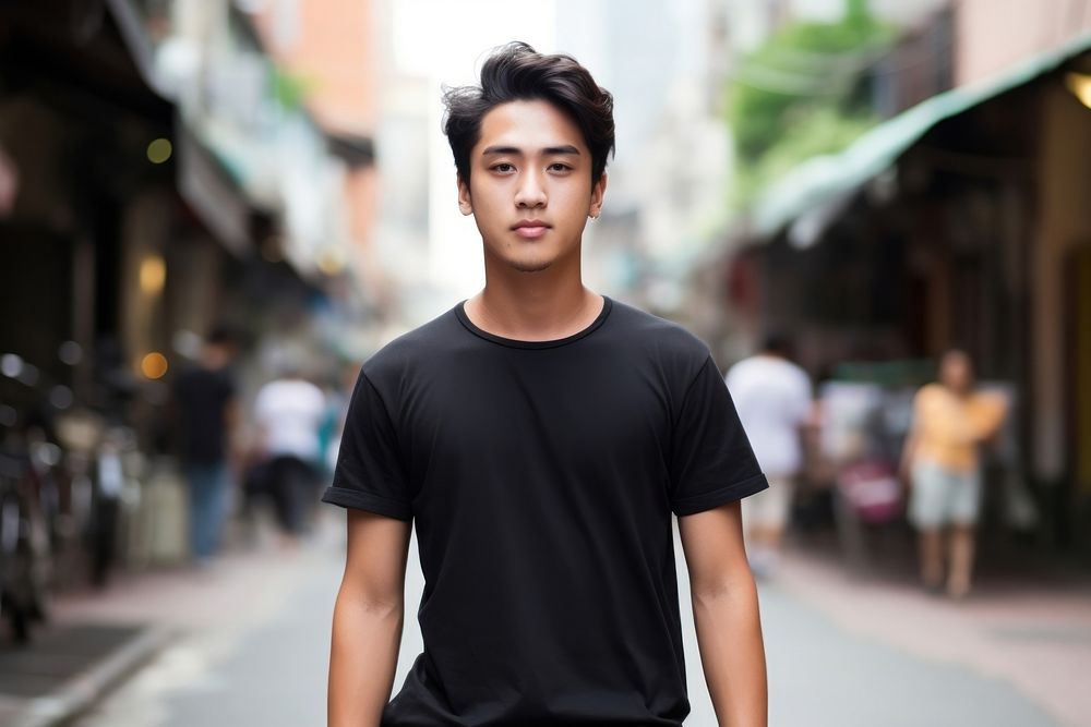 Thai teenager wearing black t-shirt walking at the urban street individuality architecture accessories. AI generated Image…