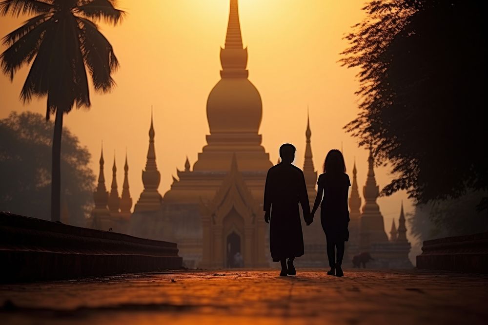 Laos couple make a merit at temple walking adult spirituality. AI generated Image by rawpixel.