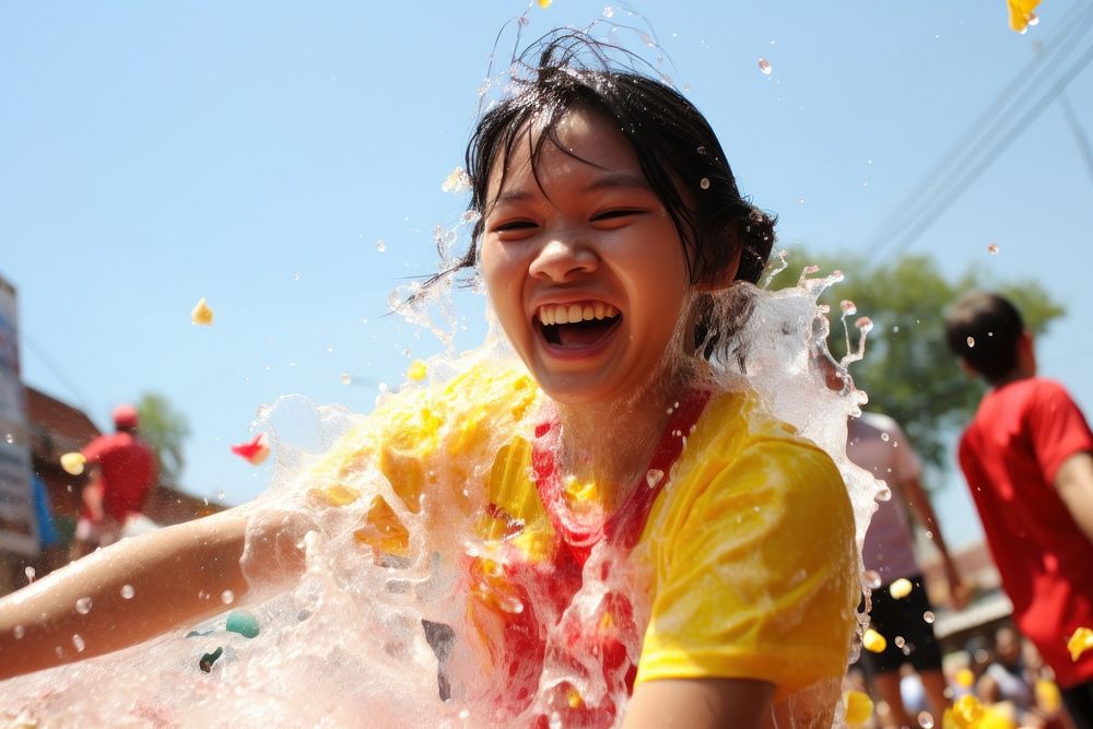 Laos teenager playing songkran festival at Vientiane laughing summer togetherness. AI generated Image by rawpixel.