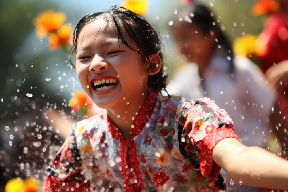 Laos teenager playing songkran festival at Vientiane laughing smile celebration. AI generated Image by rawpixel.