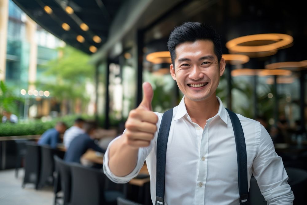 Happy asian man thumbs up standing portrait success. AI generated Image by rawpixel.