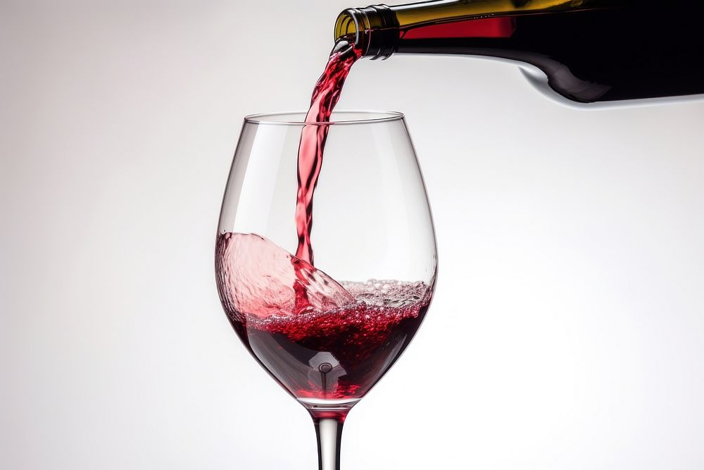 Pouring red wine in a glass pouring bottle drink. AI generated Image by rawpixel.