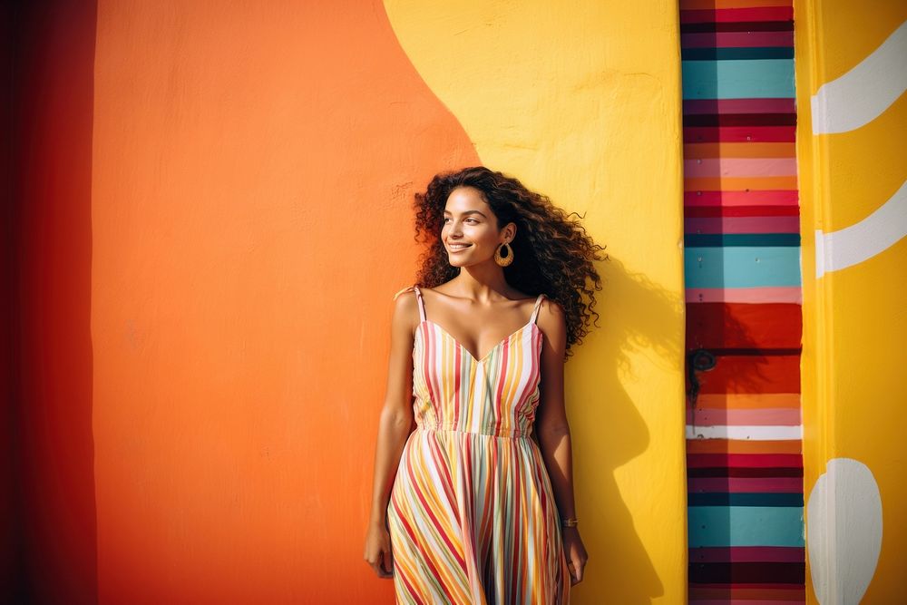 Latina woman in a sundress standing in front of a colorful wall fashion smile adult. AI generated Image by rawpixel.