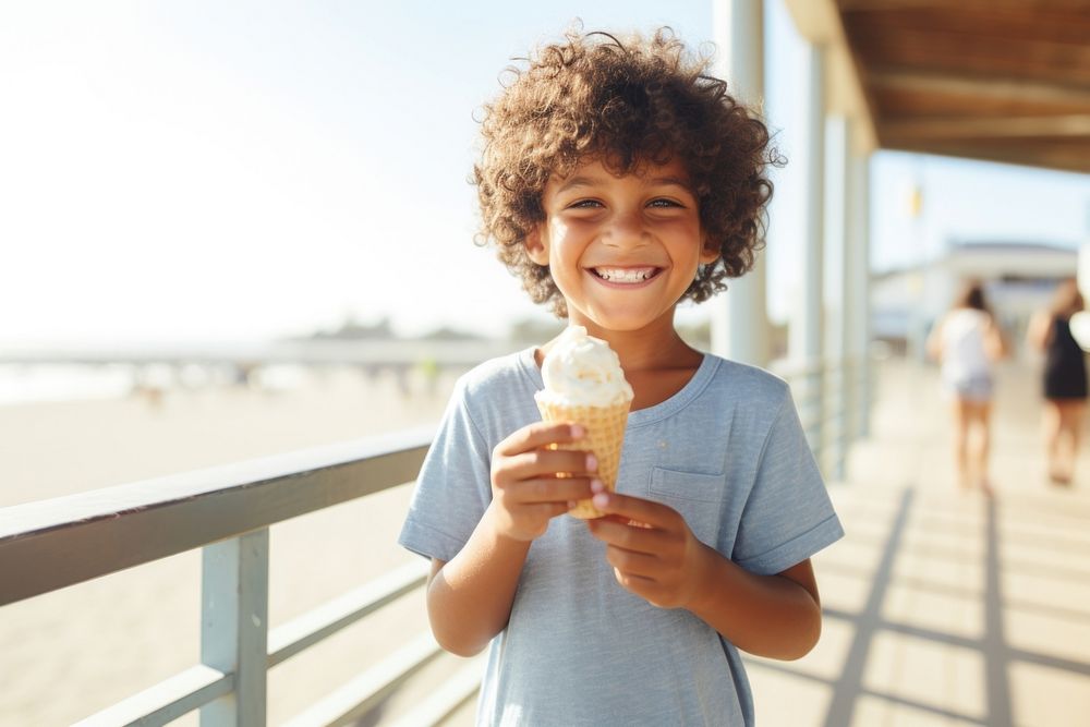 Latino boy holding an ice cream on a boardwalk against ocean background vacation summer child. AI generated Image by…