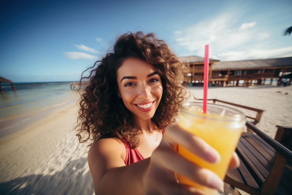 Selfie Latina woman holding a tropical drink on a beach relaxation portrait vacation. AI generated Image by rawpixel.