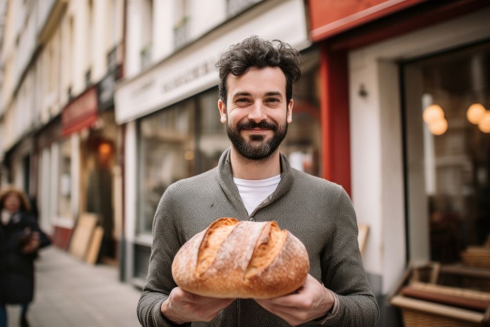 Man holding a loaf of bread bakery adult food. AI generated Image by rawpixel.