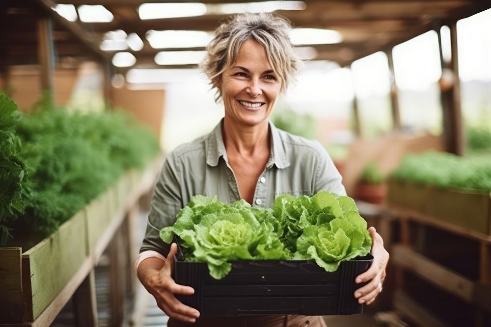 Woman holding a crate of lettuce greenhouse vegetable organic. AI generated Image by rawpixel.