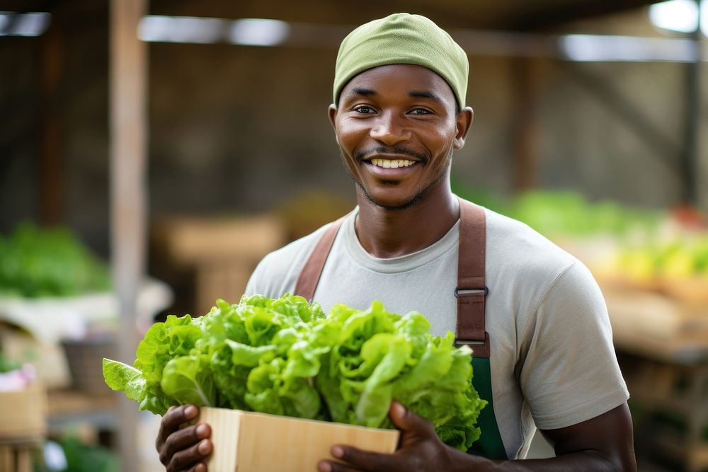 Man holding a crate of lettuce working organic farmer. AI generated Image by rawpixel.