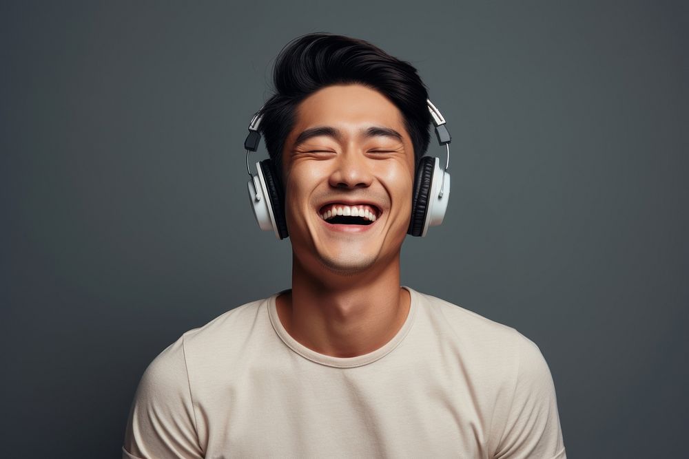 Happy Korean man headphones listening laughing. AI generated Image by rawpixel.