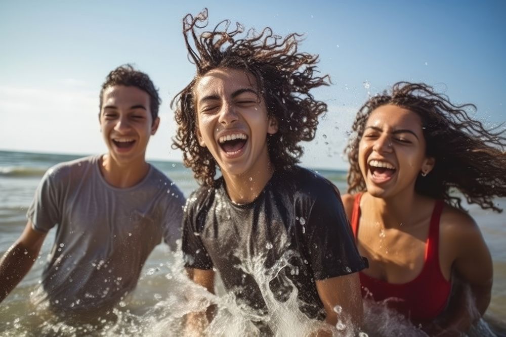 Hispanic teenage friends splashing laughing summer. AI generated Image by rawpixel.