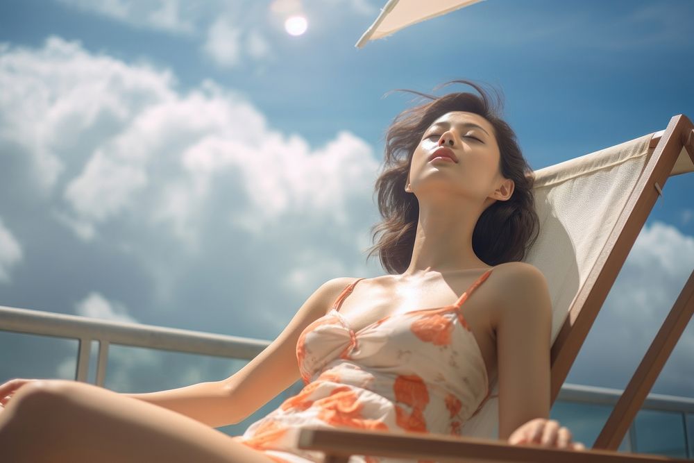 Singaporean women sunbathing sitting summer. AI generated Image by rawpixel.