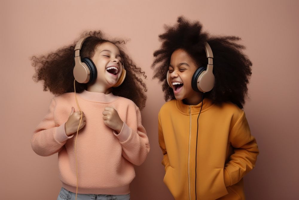 Children wearing headphone headphones listening laughing. AI generated Image by rawpixel.