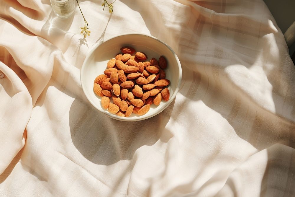 Nuts bowl almond table. AI generated Image by rawpixel.