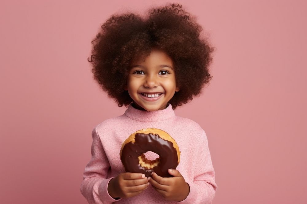 Child holding Doughnut doughnut smiling photo. AI generated Image by rawpixel.