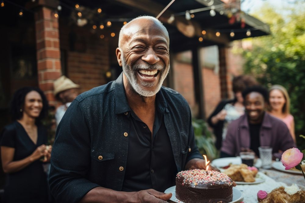 Black senior man party cake laughing. AI generated Image by rawpixel.