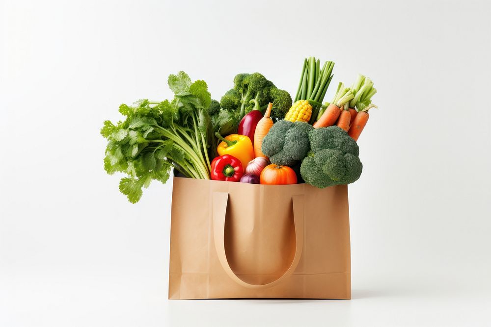 Woman holding healthy groceries in paper bag plant food white background. AI generated Image by rawpixel.