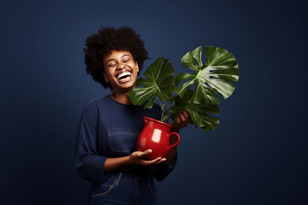 Black women laughing plant holding. AI generated Image by rawpixel.