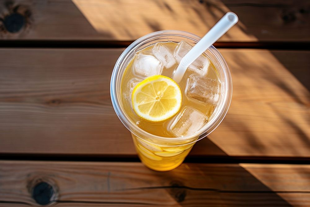 Lemonade in plastic drink table refreshment. AI generated Image by rawpixel.