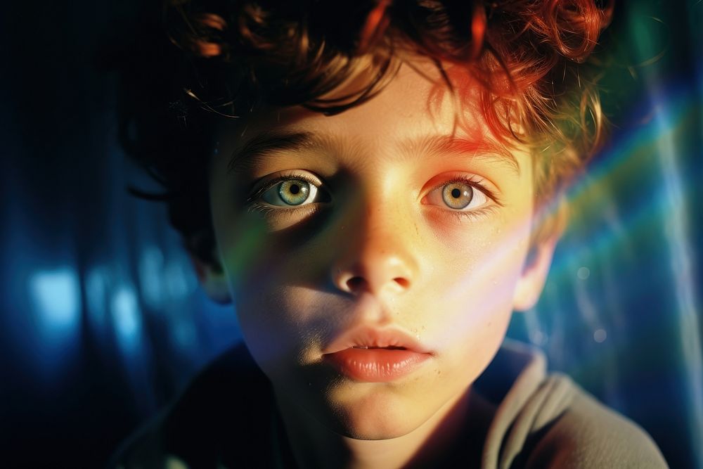 Rainbow light on boy kids face photography portrait innocence. AI generated Image by rawpixel.