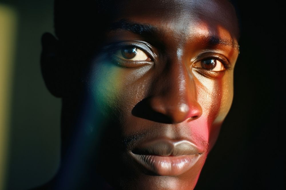 Rainbow light on black man face photography portrait adult. AI generated Image by rawpixel.