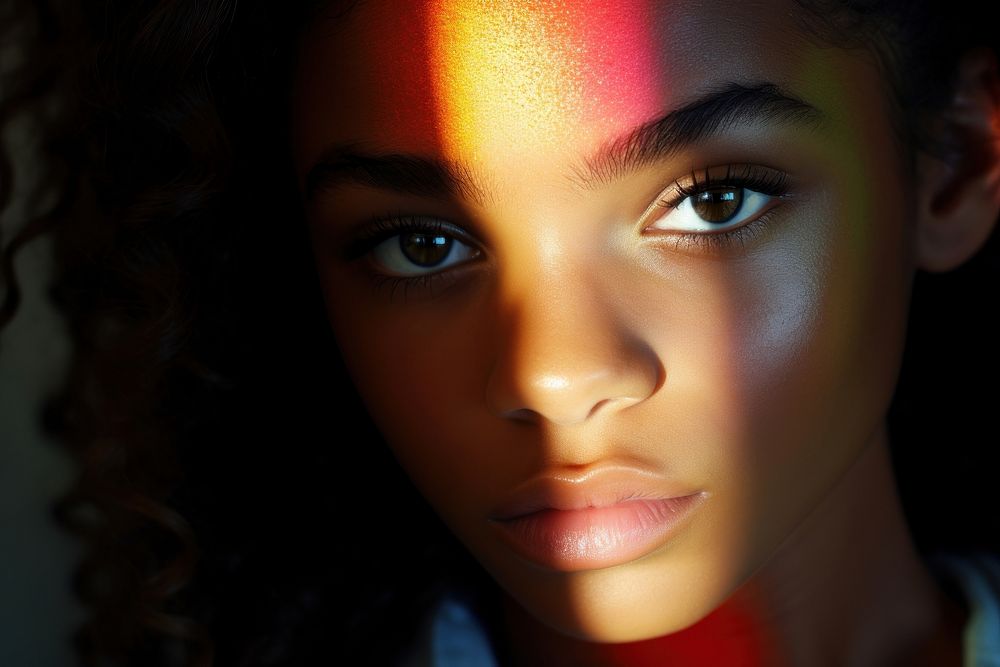 Rainbow light on black teenagers face photography portrait skin. AI generated Image by rawpixel.