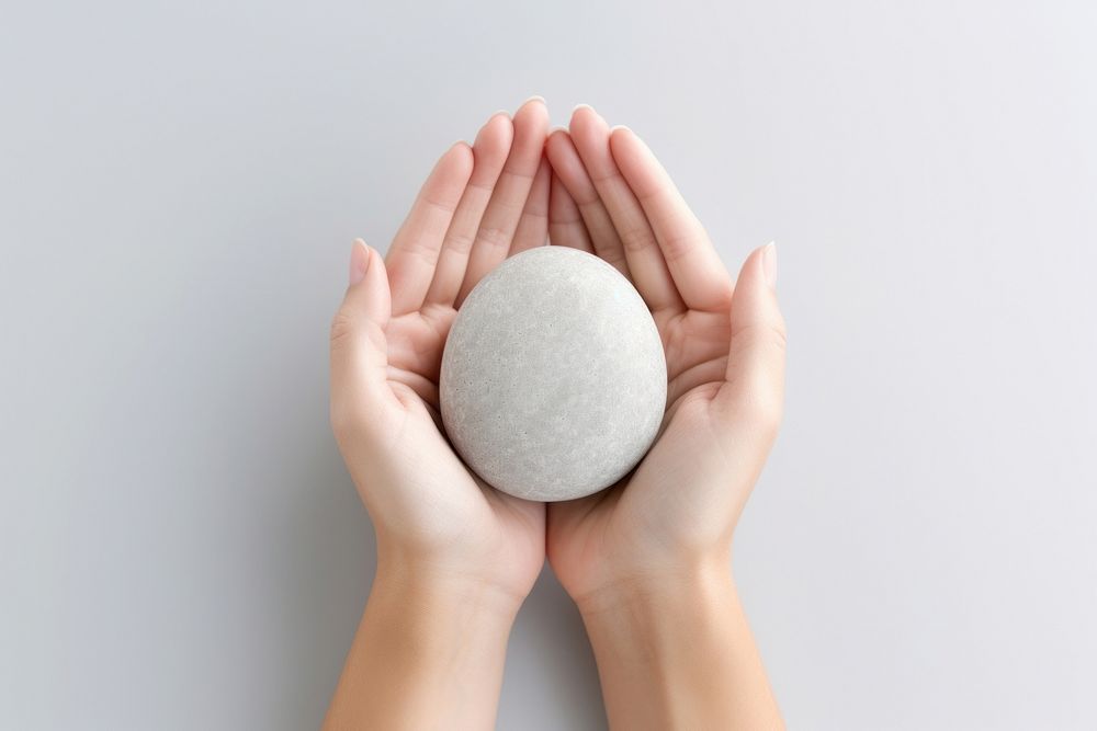 Spirituality healing zen stone holding hand egg. AI generated Image by rawpixel.