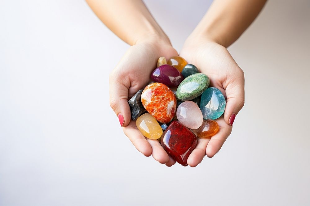 Woman hand holding Spirituality healing stones gemstone jewelry pill. AI generated Image by rawpixel.