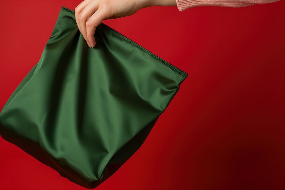 Blank fabric bag handbag holding red. AI generated Image by rawpixel.