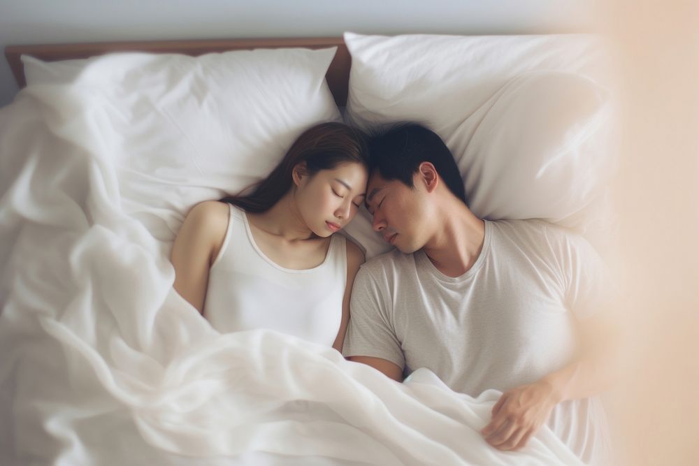 A sleeping couple furniture blanket bedroom. AI generated Image by rawpixel.