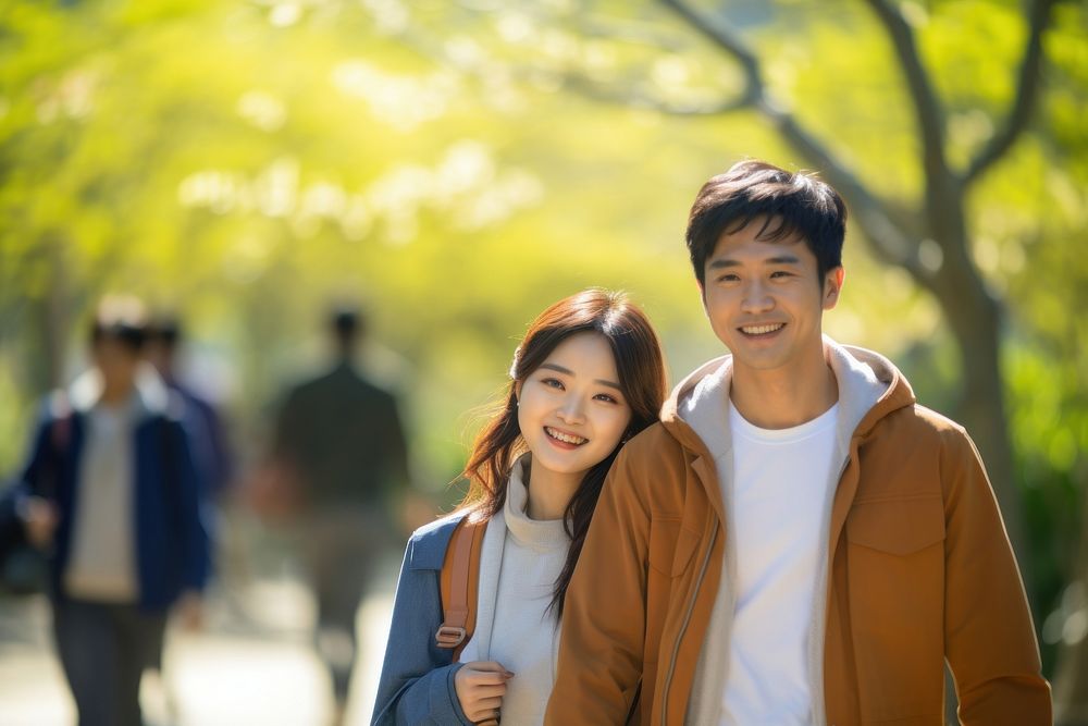 A young couple walking together in the park adult smile day. AI generated Image by rawpixel.