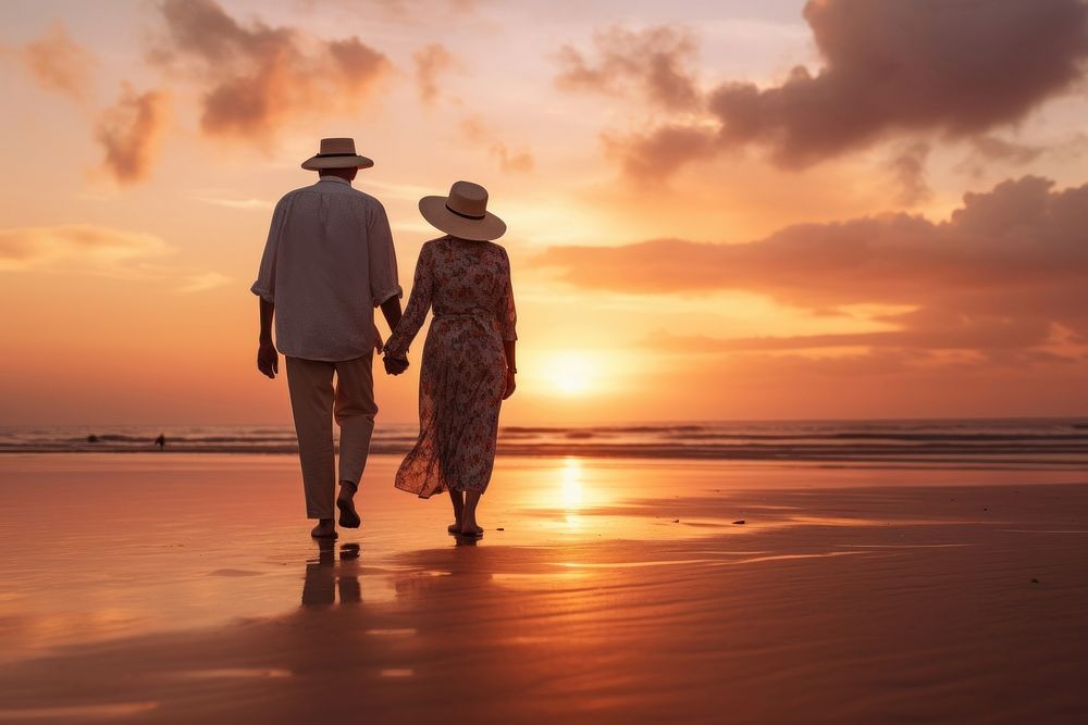 Happy senior man and woman old retired couple walking and holding hands on a beach at sunset adult sky togetherness. AI…