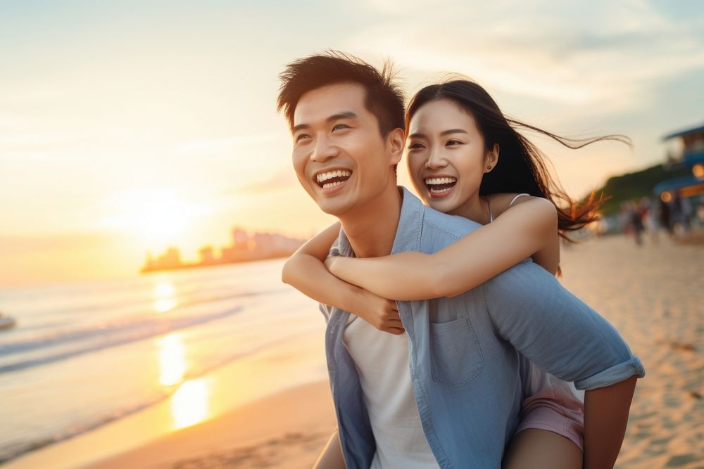 Young excited asian couple in casual clothes boyfriend give piggyback ride to joyful girlfriend laughing beach adult. AI…