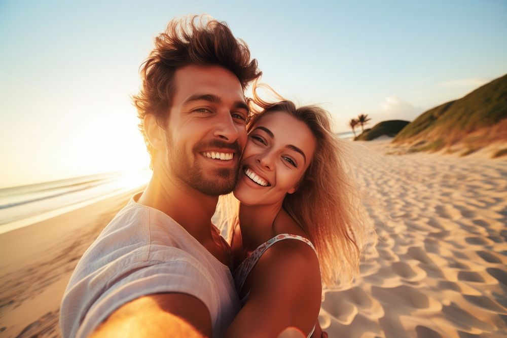 Young happy man kissing his beautiful girlfriend while taking selfie photo on sunny beach laughing outdoors nature. AI…