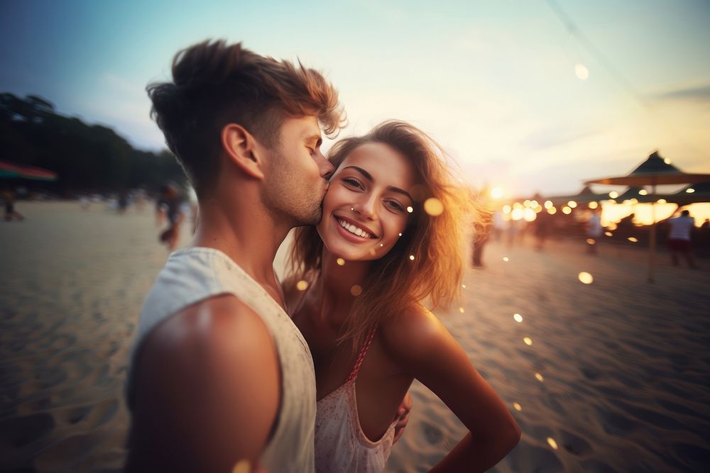 Young happy man kissing his beautiful girlfriend while taking selfie photo on sunny beach sea outdoors portrait. AI…