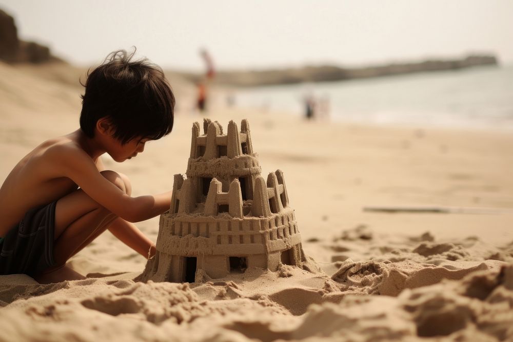 East Asian kid building sand castle outdoors beach child. AI generated Image by rawpixel.