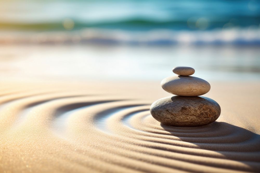 Spirituality zen stone on sand outdoors pebble nature. AI generated Image by rawpixel.
