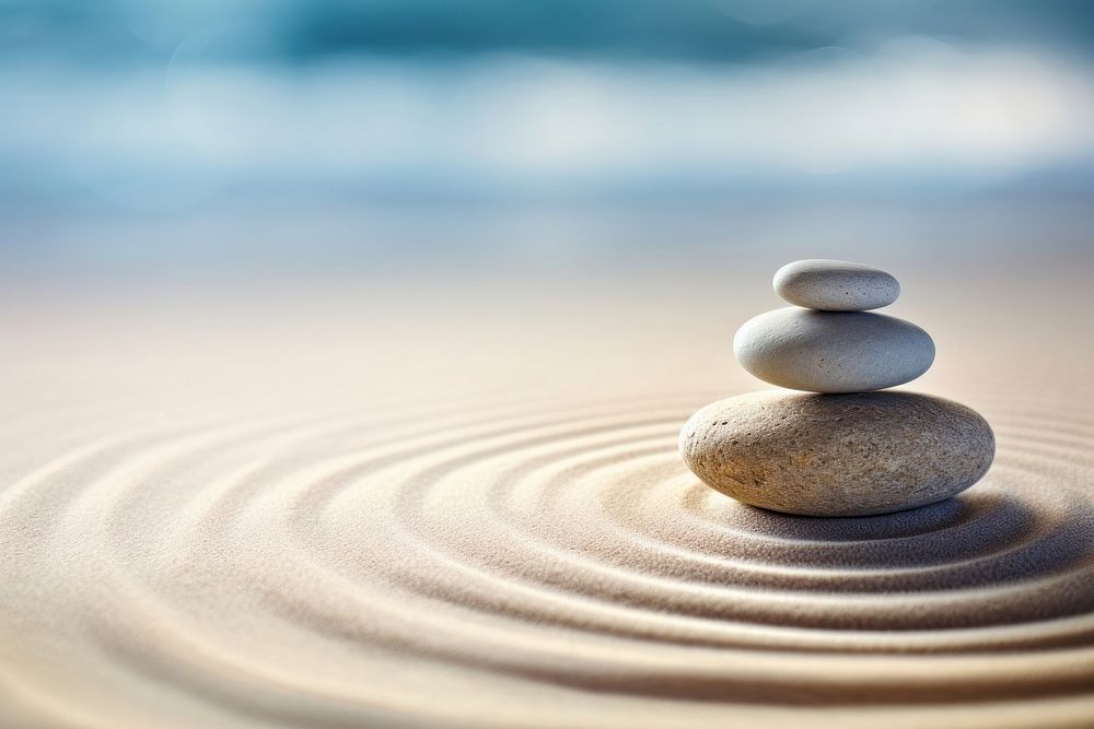 Spirituality zen stone on sand outdoors pebble nature. AI generated Image by rawpixel.