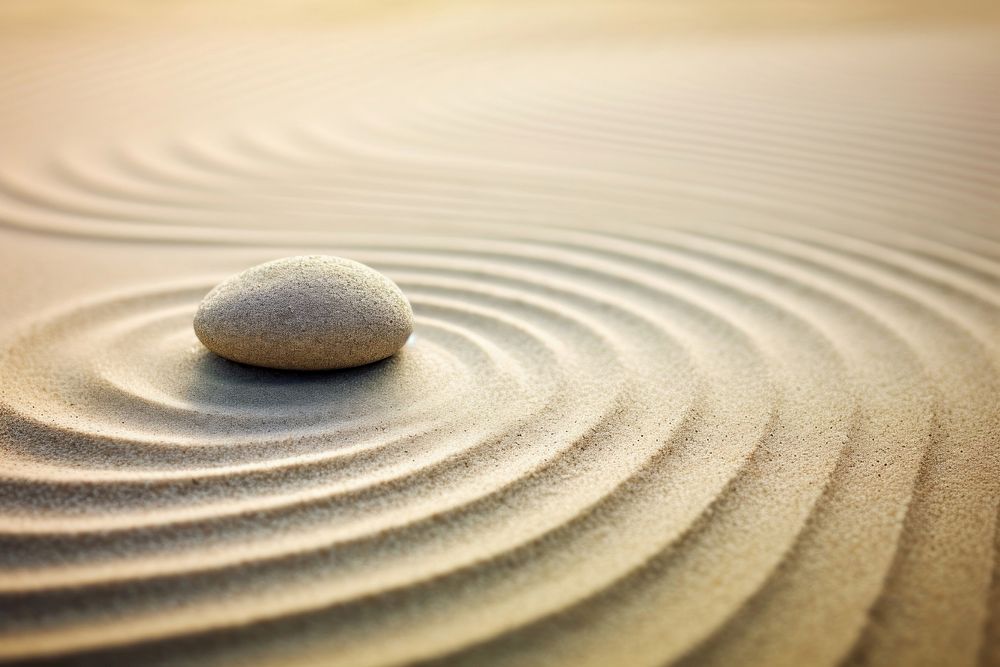 Spirituality zen stone on sand outdoors nature pebble. AI generated Image by rawpixel.