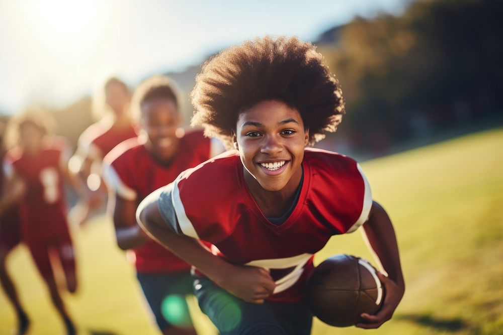 Black teen enjoy playing american football on field sports adult determination. AI generated Image by rawpixel.