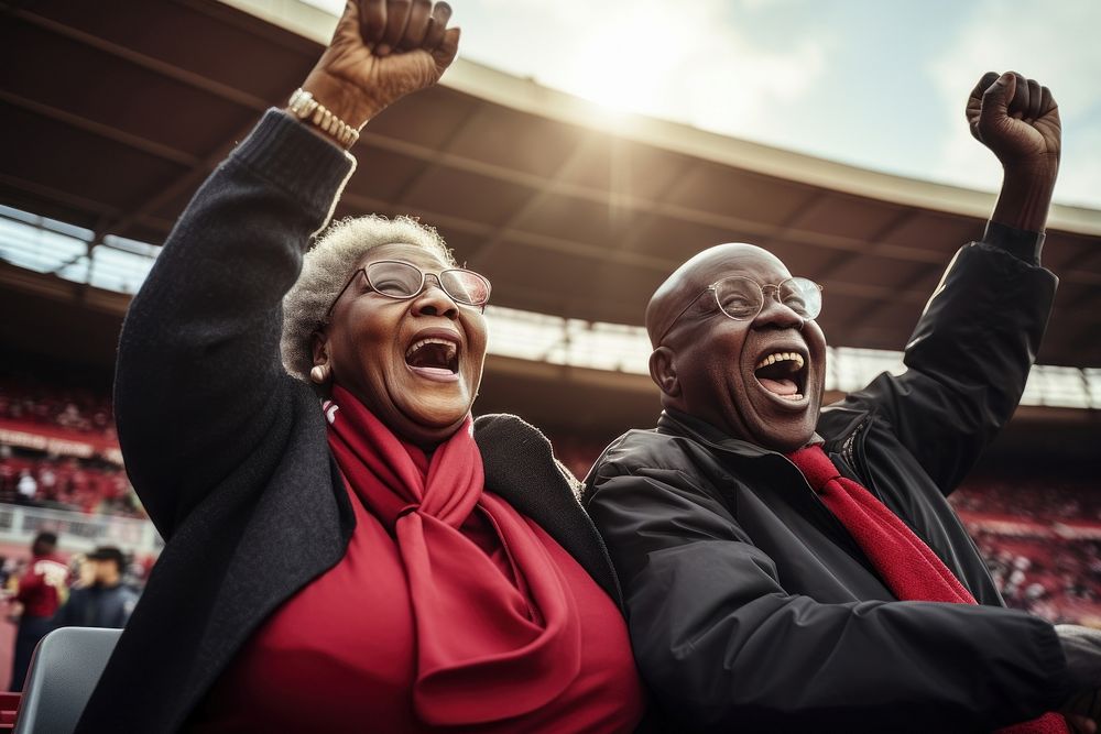 Black elder couple cheering sport game laughing stadium glasses. AI generated Image by rawpixel.